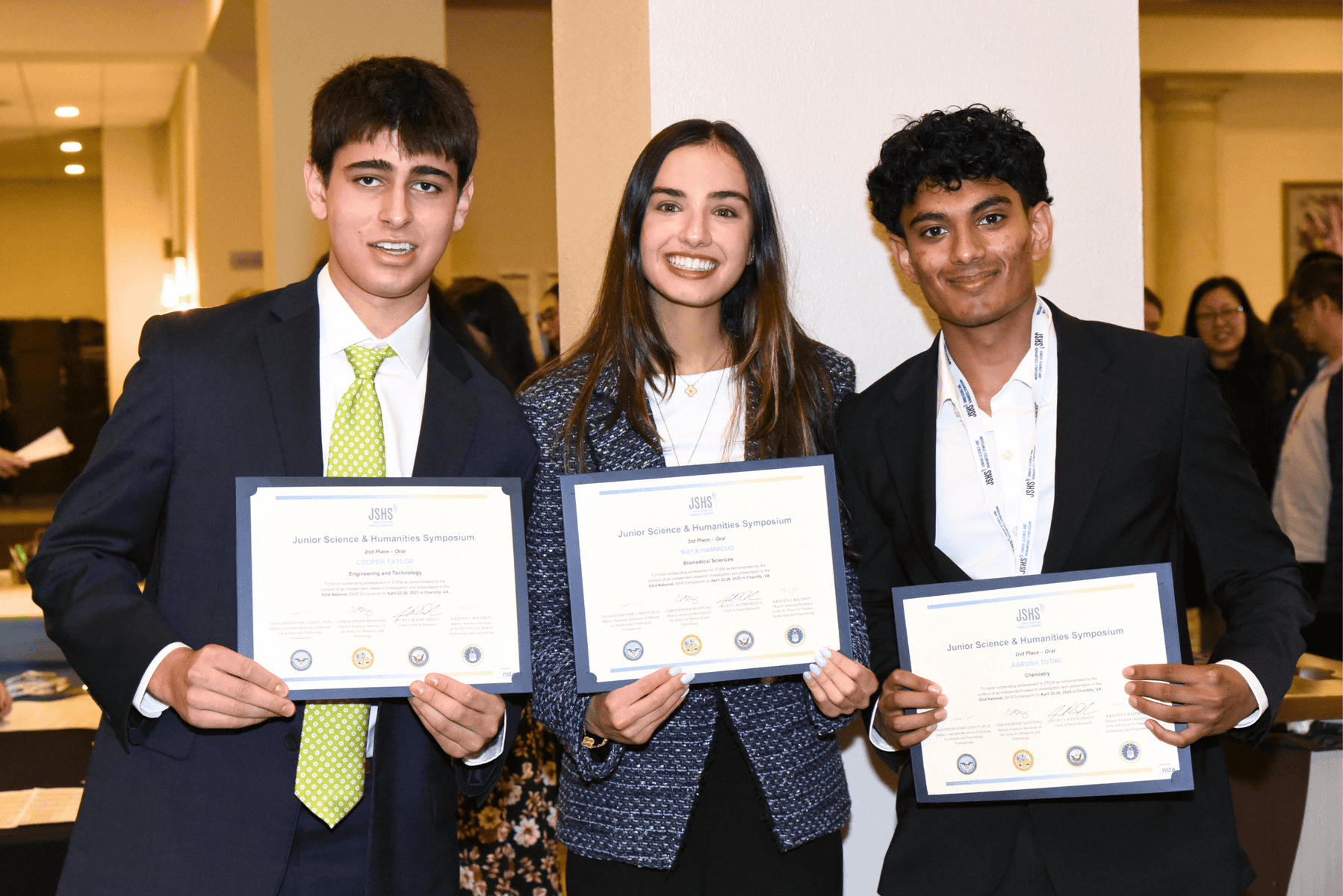 Three JSHS students displaying their award certificates