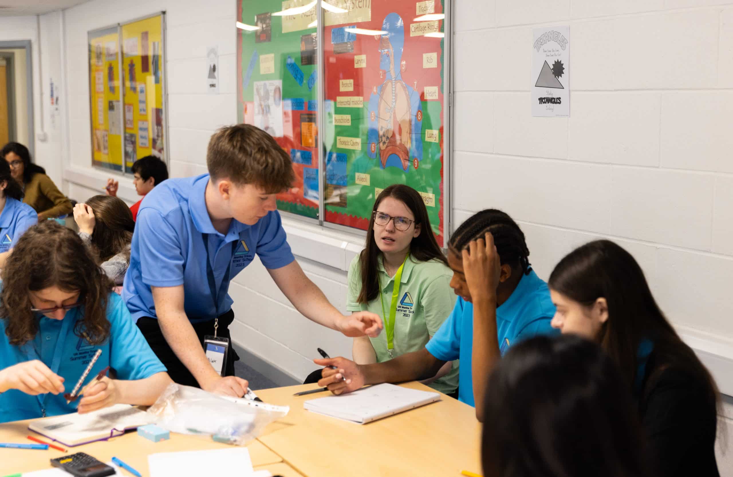 Students working together on mathematics activities around a classroom table